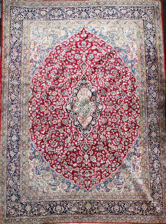 An Isfahan red and ivory ground carpet, 12ft 10in by 9ft 10in.